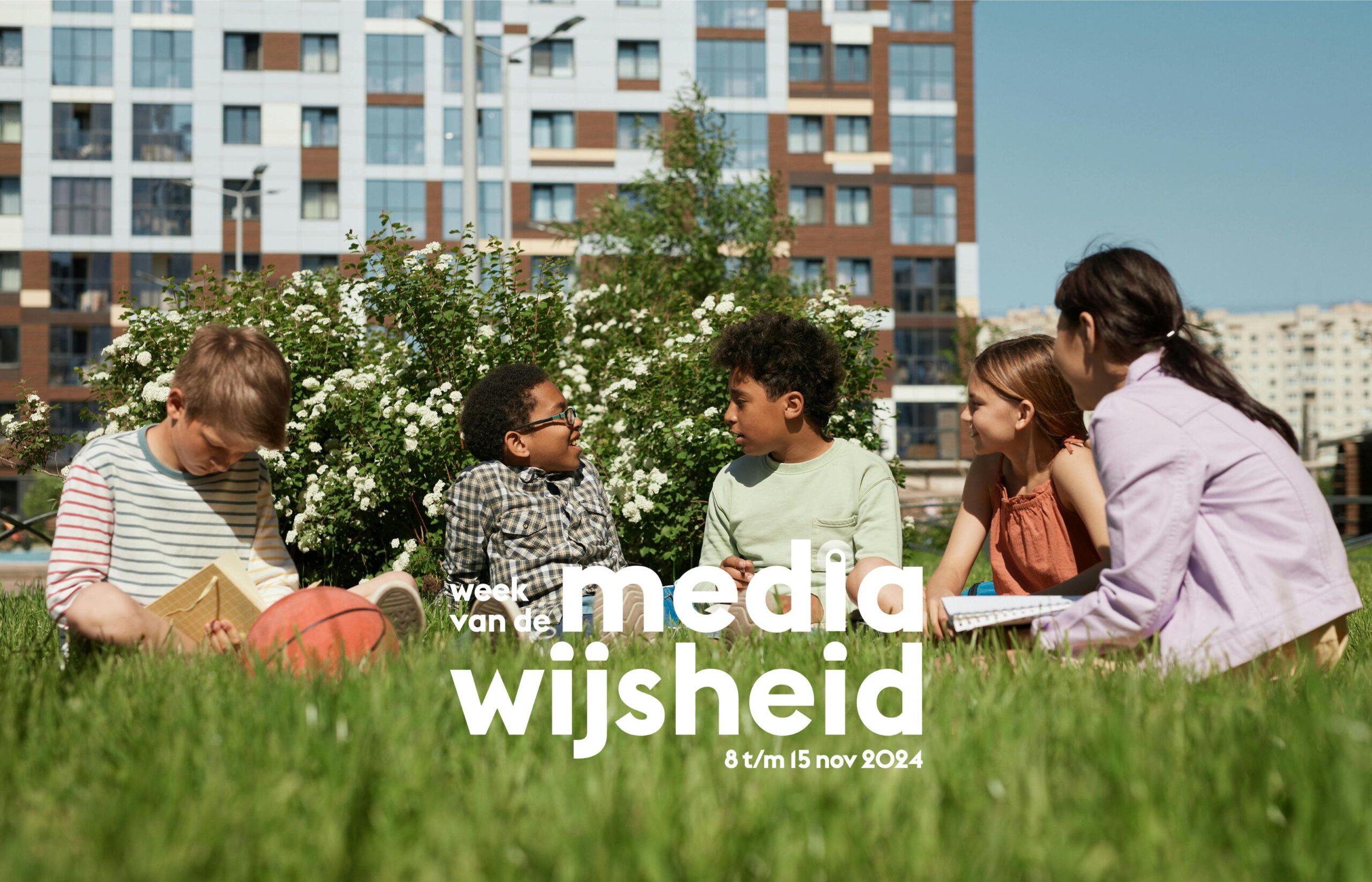 Vijf kinderen zitten in het gras